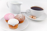 Small muffins and coffee on white plate with sugar and milk