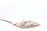 Multicolored sprinkles on the spoon