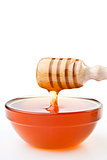 Honey dipper at horizontally  dropping a trickle of a honey 