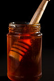 Honey dipper in a honey jar