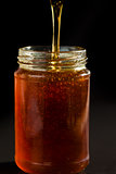 Honey trickle dropping in a honey jar