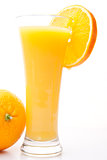 Glass of orange juice near a orange