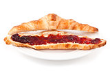 Croissant spread with jam in a plateful
