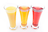 Three glasses full of fruit juice