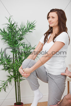 Woman standing while stretching her leg