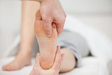 Practitioner placing his thumb on a foot