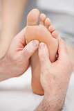 Hands massaging a foot