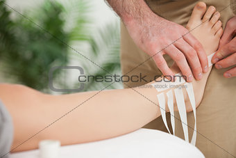 Doctor dressing an ankle