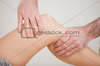 Knee of a patient being touched by a practitioner