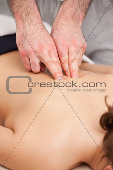 Osteopath massaging a woman in the middle of her back
