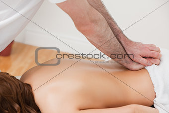 Therapist massaging the back of his patient while standing