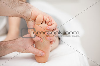 Two hands holding a foot