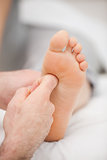 Finger massaging a foot