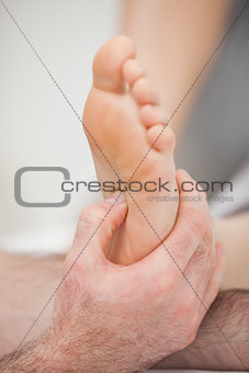 Foot being touched by a thumb