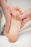 Chiropodist massaging the foot of a patient