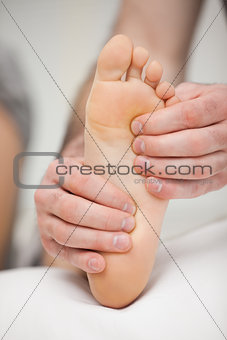 Fingertips touching the sole of a foot
