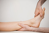 Side view of a foot being massaged