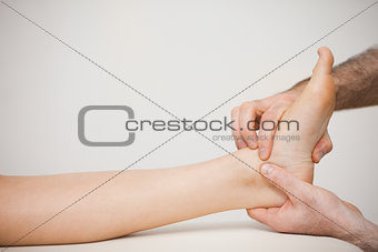 Doctor placing his fingers on the foot of a patient