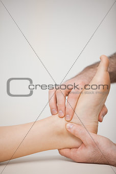 Doctor massaging the side of a foot