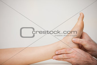 Chiropodist examining the foot of a patient