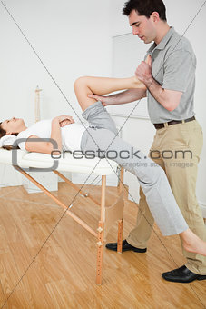 Woman putting her foot on the chest of her doctor 