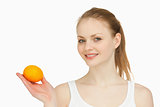 Woman holding a tangerine in her hand