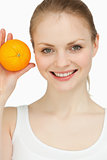 Smiling blonde-haired presenting an orange