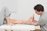 Calf of a patient being massaged by a physiotherapist