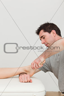 Serious practitioner holding the foot of a patient