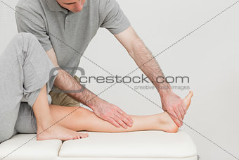 Calf of a patient being stretched by a doctor