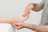 Doctor holding the foot of a patient