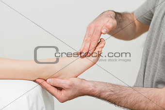 Doctor holding the foot of a patient