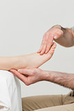 Practitioner holding the foot of a patient