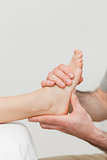 Hands of a physiotherapist massaging a foot