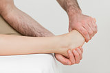 Osteopath holding the ball of the foot of a patient