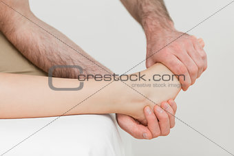 Osteopath holding the ball of the foot of a patient