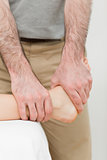 Osteopath manipulating the ankle of a patient