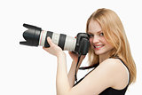 Woman looking at the camera while holding a camera