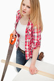 Woman using a wood saw