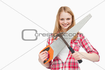 Woman holding a hammer and a saw