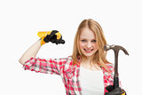 Woman smiling while holding a hammer