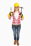 Woman wearing a safty helmet while holding tools