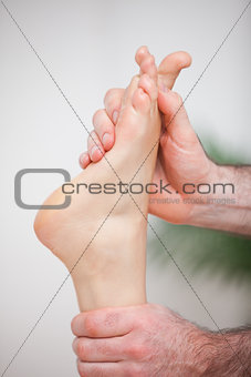 Doctor massaging the foot of his patient