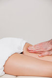 Osteopath massaging a woman on her thigh