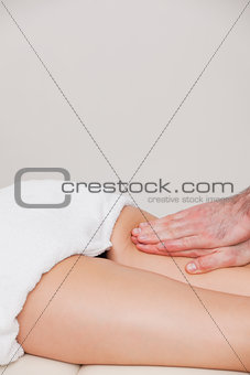 Osteopath massaging a woman on her thigh