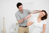 Woman being examined her neck by a doctor 