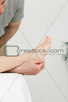Podiatrist examining the foot of his patient