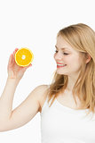 Joyful woman holding an orange