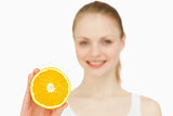 Smiling woman holding an orange