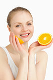 Cheerful woman holding oranges while smiling